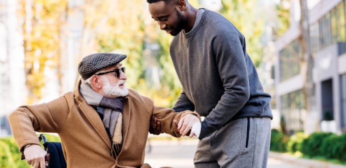 Caregiver-helping-elderly-man-out-of-wheelchair.jpg